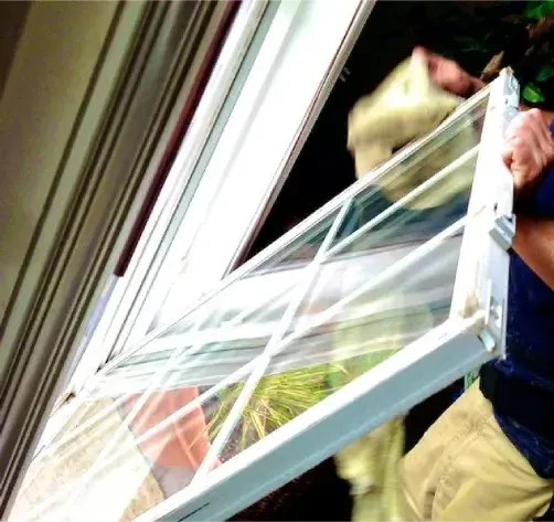 A man from Bethany Associates cleaning window in a kitchen